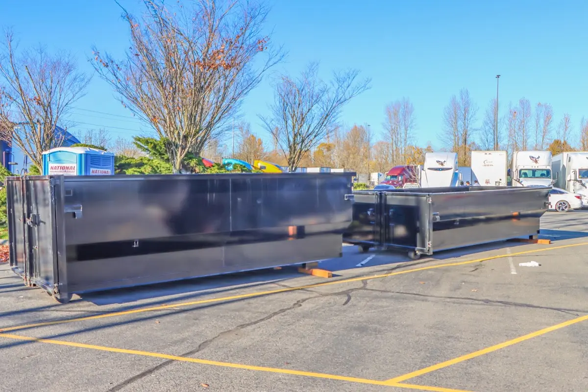 Professional dumpster rental service with roll-off container on residential driveway in Murraysville